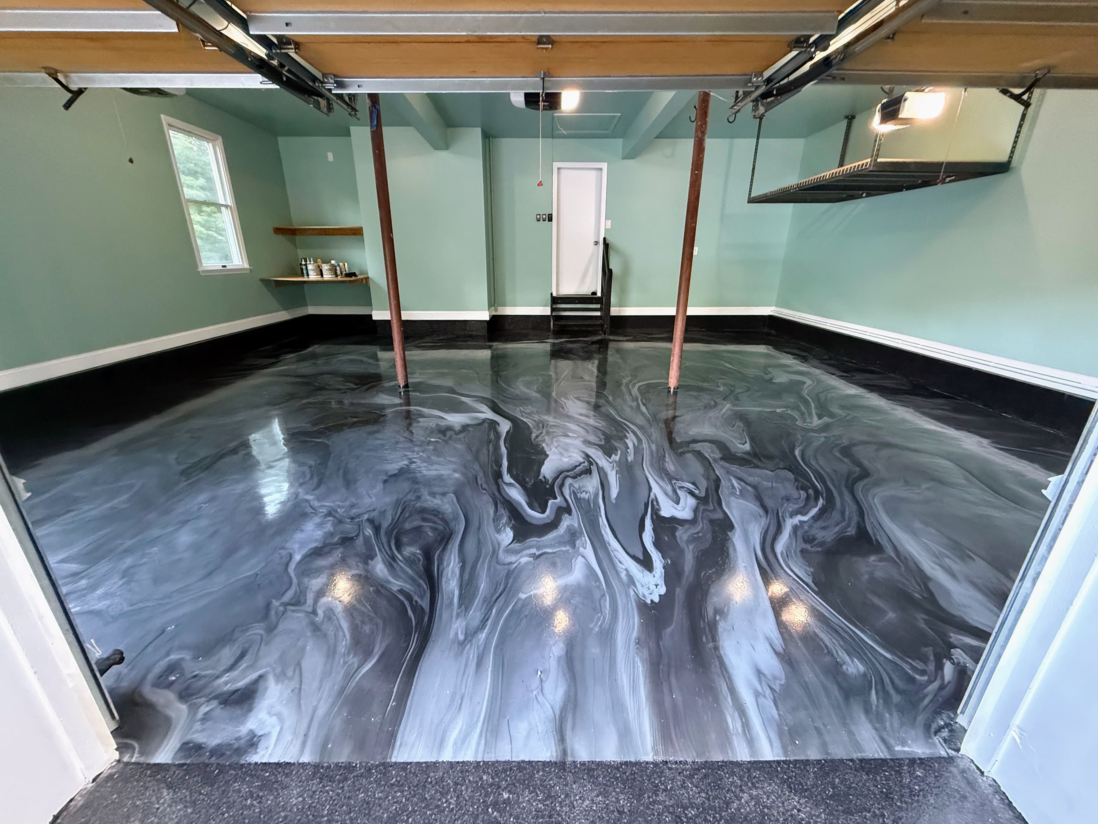 Custom black, gray, and white swirl epoxy garage floor in Chester, NY