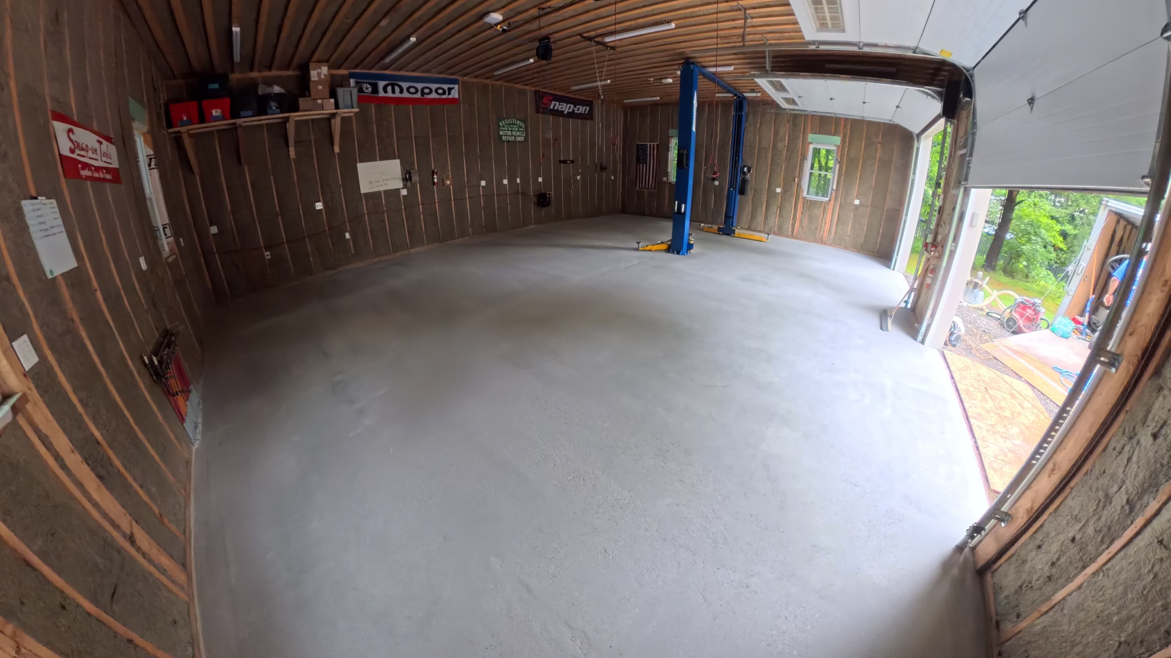 Mechanic's shop concrete floor with vehicle lifts before epoxy installation in Kerhonkson, NY