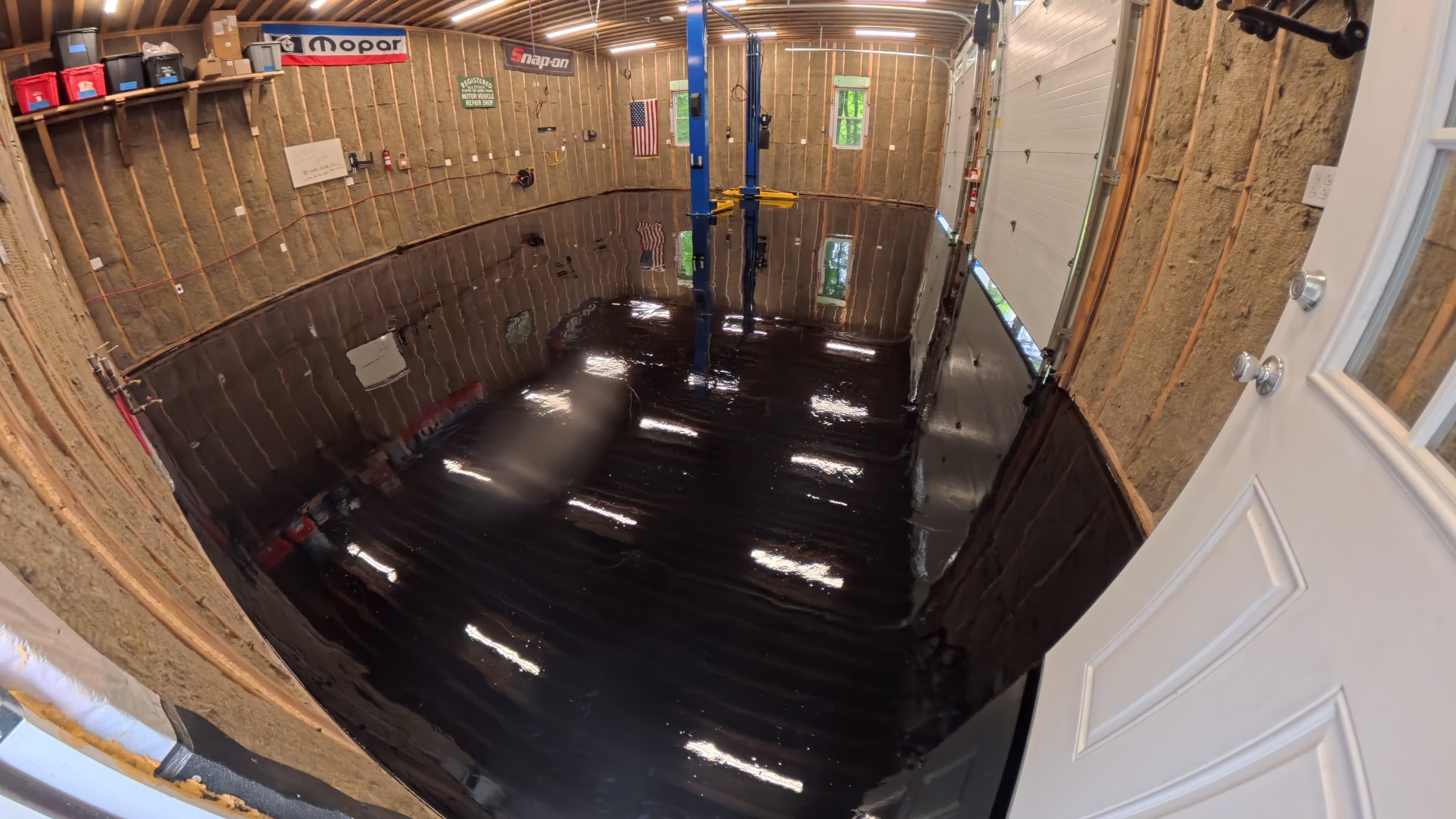 Black epoxy base coat applied to the mechanic's shop floor in Kerhonkson, NY